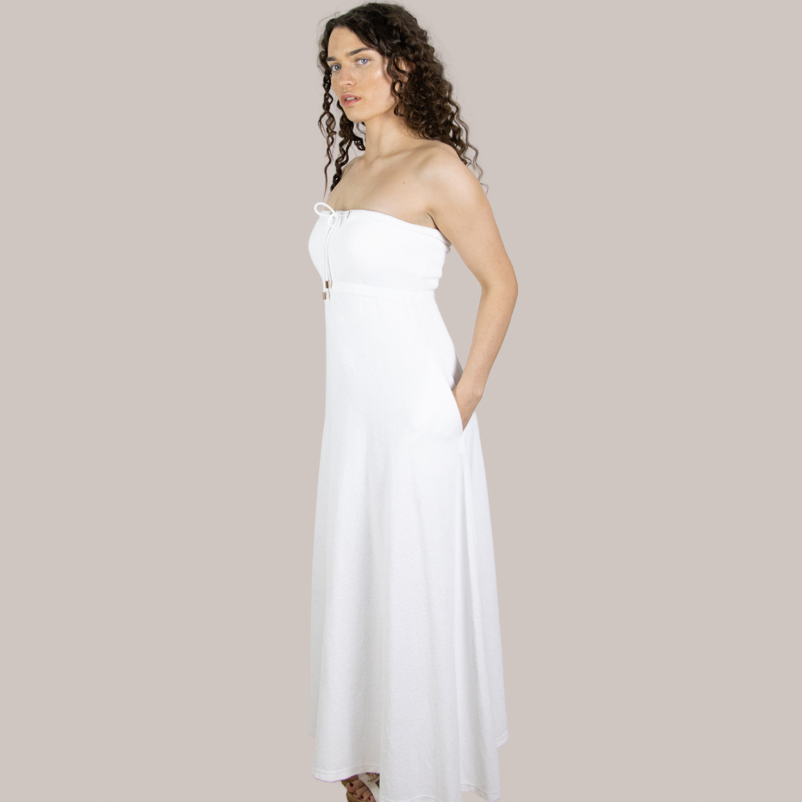 Elegant white long towel dress side view. Soft towelling, quick-drying, and designed for effortless style for maternity, at home, beach, bar or boat.