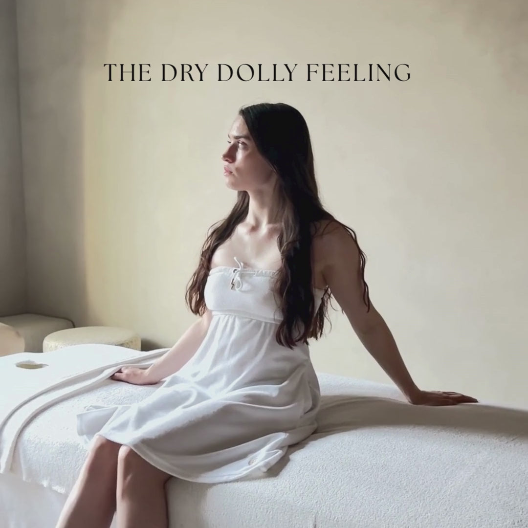 Video close-up of the Dry Dolly towel dress highlighting its soft towelling fabric, quality stitching and luxury feel.